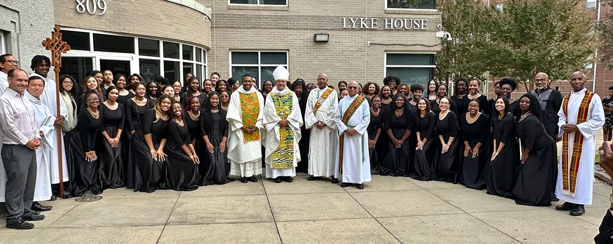 25th anniversary Mass Celebrants and choir group photo in front of the Lyke House